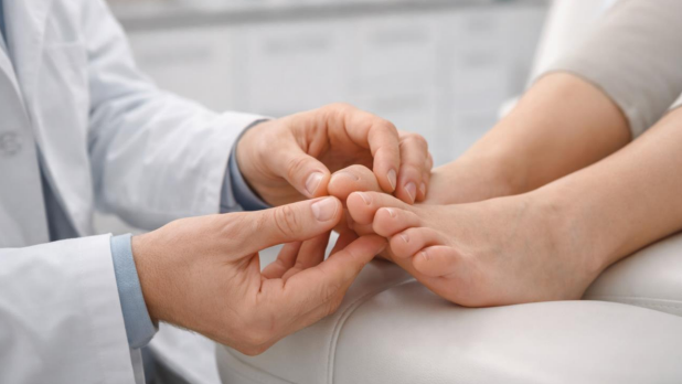 Podiatrist evaluating hammertoe as part of hammertoes treatments