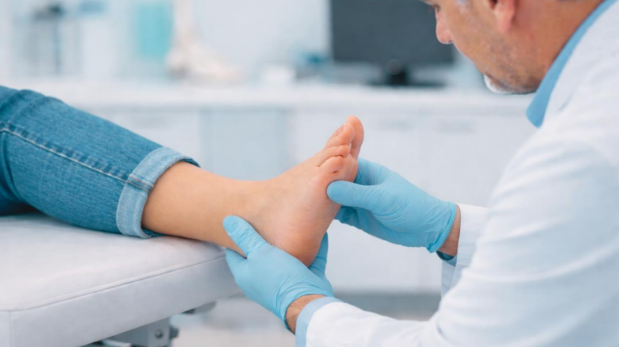 Podiatrist evaluating heel pain during podiatry appointment